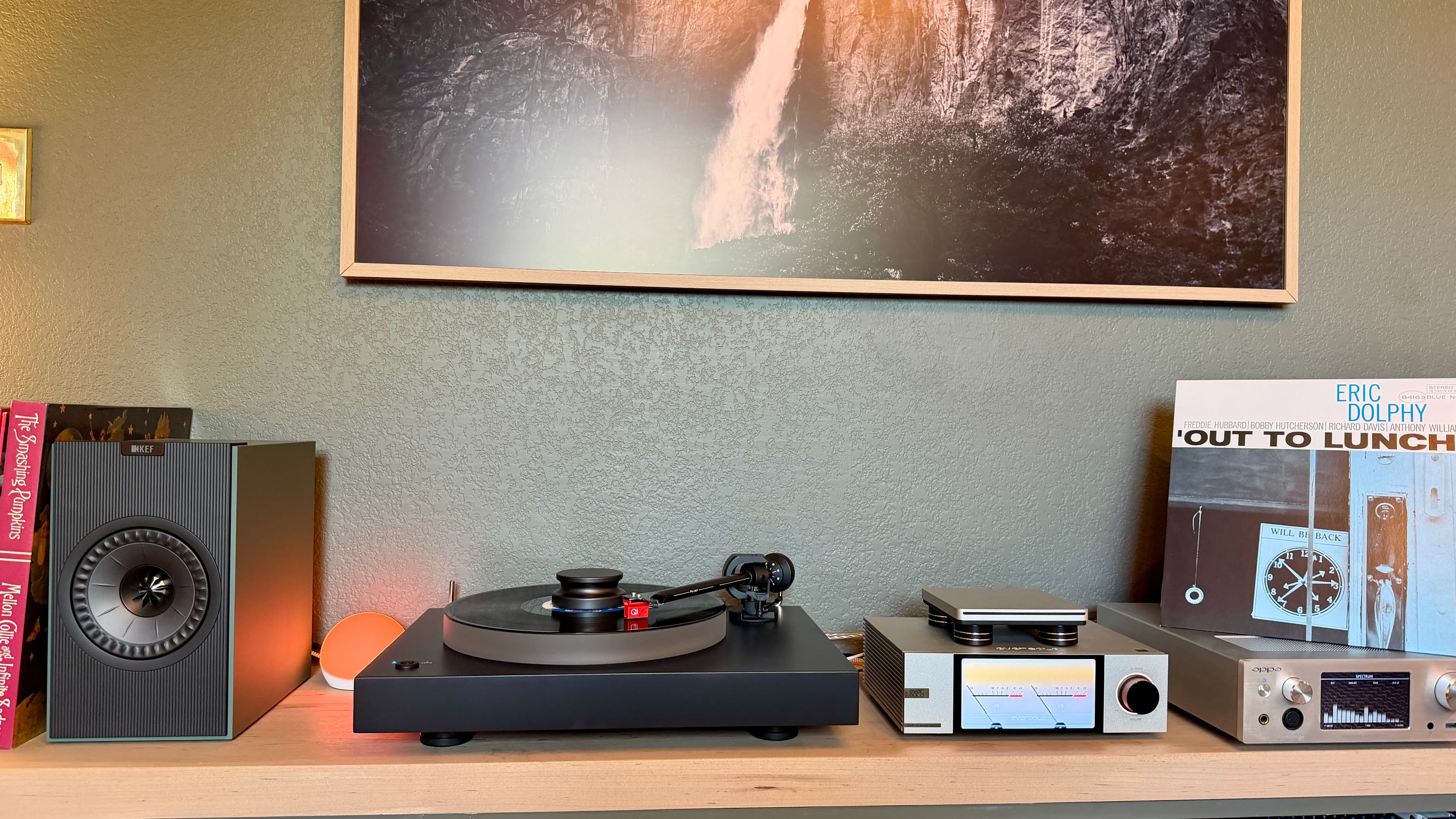 A turntable and speaker setup on a shelf