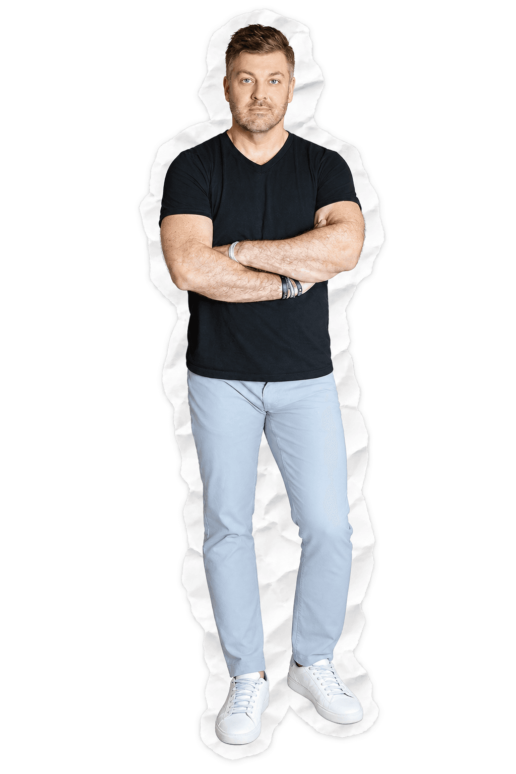 Brad Grabowski standing with arms crossed, in a black tee and light blue pants, cut out like torn paper